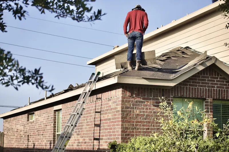 Professional roofer working on a residential roof in Larissa
